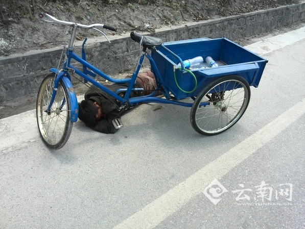  拾荒老汉醉卧公路边 巡逻交警将其唤醒（图）